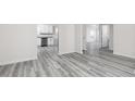 Open living space showcases gray floors, white walls, and seamless flow to the kitchen area at 425 Prescott Way, Villa Rica, GA 30180