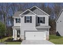 Charming two-story home with gray siding, black shutters, and a two-car garage at 439 Prescott Way, Villa Rica, GA 30180