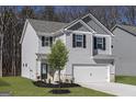 Charming two-story home with gray siding, black shutters, and a two-car garage at 439 Prescott Way, Villa Rica, GA 30180