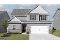 Charming two-story home with gray siding, dark shutters, and a two-car garage at 443 Prescott Way, Villa Rica, GA 30180
