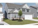 A beautiful two-story home with gray siding, a two-car garage, and a well-maintained lawn at 448 Prescott Way, Villa Rica, GA 30180