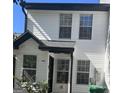 Charming two-story townhouse with white siding and black trim around the windows and entryway at 2353 Wellington Cir, Lithonia, GA 30058