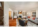 Stylish living room featuring a gray sofa, fireplace, decor, and an open layout with hardwood flooring at 1928 Main Nw St, Atlanta, GA 30318