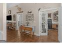 Inviting living room featuring hardwood floors, a console table, and an open doorway to an adjacent room at 1103 Wilder Ct, Mcdonough, GA 30252