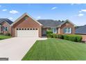 Well-maintained brick home featuring a manicured lawn and neutral shutters at 375 Oakpark Ter, Mcdonough, GA 30253