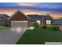 Beautiful brick home with a well-kept lawn, shown during twilight at 375 Oakpark Ter, Mcdonough, GA 30253