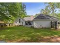 Exterior of home with a spacious backyard, patio, and privacy fence at 1291 Interlaken Pass, Jonesboro, GA 30238