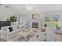 Bright living room featuring a fireplace, white sofas, and neutral decor at 1291 Interlaken Pass, Jonesboro, GA 30238