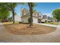 Suburban home exterior with trees, lawn, and driveway at 4376 Grant Forest Cir, Ellenwood, GA 30294