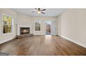 Bright living room boasts a fireplace, large windows, and hardwood floors at 2373 Aukerman Trce # 83, Hampton, GA 30228