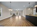 Spacious living room featuring wood floors, a fireplace, and plenty of natural light at 2373 Aukerman Trce # 83, Hampton, GA 30228