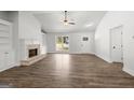 Bright living room showcasing wood floors, brick fireplace, and built-in shelving with natural light at 3261 Broadnax Mill Rd # 2, Loganville, GA 30052