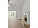 Bright living room with a brick fireplace, ceiling fan, and large window for lots of natural light at 3245 Broadnax Mill Rd # 7, Loganville, GA 30052