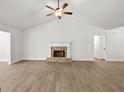 Spacious living room featuring light colored floors, a brick fireplace, and ceiling fan at 3245 Broadnax Mill Rd # 7, Loganville, GA 30052