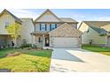 Charming two-story home with brick accents, a welcoming front yard and a paved driveway at 2381 Aukerman Trce # 81, Hampton, GA 30228