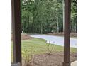 Beautiful view of the driveway surrounded by lush greenery and natural landscaping at 6093 Wayfarer Dr, Villa Rica, GA 30180