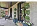 Charming entrance with modern decor and stylish planters, offering a welcoming ambiance at 145 Kelmscott Ln, Fayetteville, GA 30214