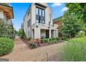 Stylish white brick home featuring a balcony and beautifully landscaped front yard at 145 Kelmscott Ln, Fayetteville, GA 30214