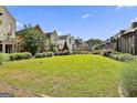 Expansive community green space surrounded by a variety of upscale modern homes and lush landscaping at 145 Kelmscott Ln, Fayetteville, GA 30214