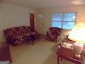 Inviting living room showcasing floral sofa and chair, a cozy space for relaxation with natural light at 1320 Labelle St, Jonesboro, GA 30238
