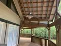 Covered outdoor patio and fan, perfect for enjoying the outdoors and private wooded views at 3255 Flat Shoals Sw Rd, Conyers, GA 30094