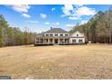 Charming two-story home with a spacious front yard and classic architectural details at 203 Shelby Ln, Fayetteville, GA 30215