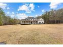 Charming two-story home with a spacious front yard and classic architectural details at 203 Shelby Ln, Fayetteville, GA 30215