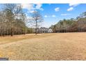 Charming two-story home with a spacious front yard and classic architectural details at 203 Shelby Ln, Fayetteville, GA 30215