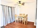 Bright dining area with wooden table set and a modern ceiling fan, bathed in natural light at 1448 Pine Log Ne Rd # C, Conyers, GA 30012