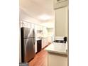 Bright kitchen featuring white cabinets, marble countertops, and stainless steel appliances at 1448 Pine Log Ne Rd # C, Conyers, GA 30012