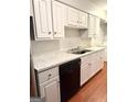 Kitchen featuring white cabinetry, dark appliances and light-colored countertops at 1448 Pine Log Ne Rd # C, Conyers, GA 30012