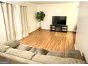 Inviting living room with hardwood floors and a comfortable couch for relaxation and entertainment at 1448 Pine Log Ne Rd # C, Conyers, GA 30012