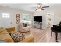 Cozy living room with wood floors, plush seating, and an open doorway to the bedroom at 45 Plantation Ln, Locust Grove, GA 30248