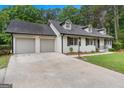 Side view of home, showcasing a spacious driveway and attached two-car garage at 380 Grady Ave, Fayetteville, GA 30214