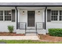 Close-up view of the front entrance with black railings and a step-up porch at 380 Grady Ave, Fayetteville, GA 30214