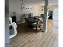 Open dining area featuring wood floors and a view of the fireplace at 45 Fieldview Ln, Covington, GA 30016