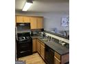 Efficient kitchen with ample cabinet space and modern black appliances at 45 Fieldview Ln, Covington, GA 30016