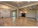 Open living room with hardwood floors, exposed beams and brick fireplace at 1147 Tanglewood Rd, Jonesboro, GA 30236