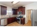 Bright kitchen featuring stainless steel appliances and dark wood cabinets at 1281 Heartwood Ave, Mcdonough, GA 30253