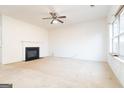 Spacious living room with a cozy fireplace and large windows for ample natural light at 1281 Heartwood Ave, Mcdonough, GA 30253
