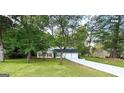Charming single-Gathering home with a landscaped yard and two-car garage, surrounded by mature trees at 104 Hillmont Dr, Woodstock, GA 30188