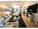Spacious living room with hardwood floors, ceiling fan, and comfortable seating arrangements at 104 Hillmont Dr, Woodstock, GA 30188
