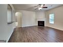 Comfortable living room with a fireplace, hardwood floors, and plenty of natural light at 749 Rolling Downs Dr, Loganville, GA 30052