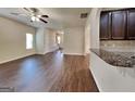 Open-concept living space features hardwood floors, neutral paint, and lots of natural light at 749 Rolling Downs Dr, Loganville, GA 30052