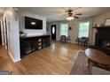 Bright living room boasts hardwood floors, fireplace, and modern entertainment center at 800 Attaway Rd, Bowdon, GA 30108