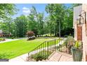 Beautiful manicured front yard featuring mature landscaping and brick walkway at 255 Emerald Lake Dr, Fayetteville, GA 30215