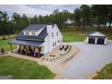 Charming farmhouse-style home featuring a covered porch and separate garage at 211 Hogan Coweta Rd, Hogansville, GA 30230