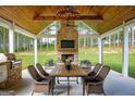 Inviting outdoor patio with fireplace, dining table, and comfortable seating at 211 Hogan Coweta Rd, Hogansville, GA 30230