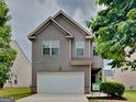Charming two-story home features a symmetrical front elevation with a well-manicured lawn at 1392 Worcester Trl, Mcdonough, GA 30253