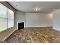 The living room features attractive hardwood flooring and a cozy fireplace at 1392 Worcester Trl, Mcdonough, GA 30253